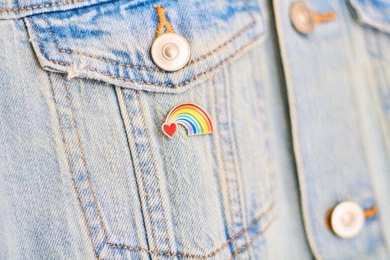 Close-up of a LGBTQ heart rainbow badge on denim jacket pocket