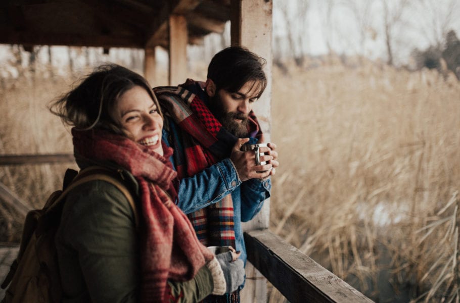 Happy couple drinking hot tea on a cold day