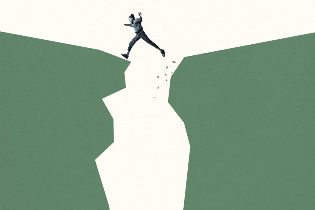 Young woman jumping over green cliffs against white background