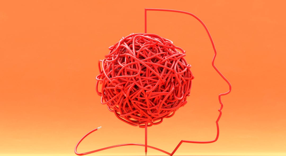 shape of face outlined by a long pencil that has the middle of the pencil tangled and knotted into a large messy ball depicting mental issues such as writers block or dyslexia
