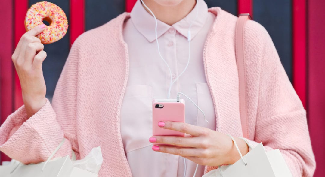 Pink Shopping Lady with doughnut using technology