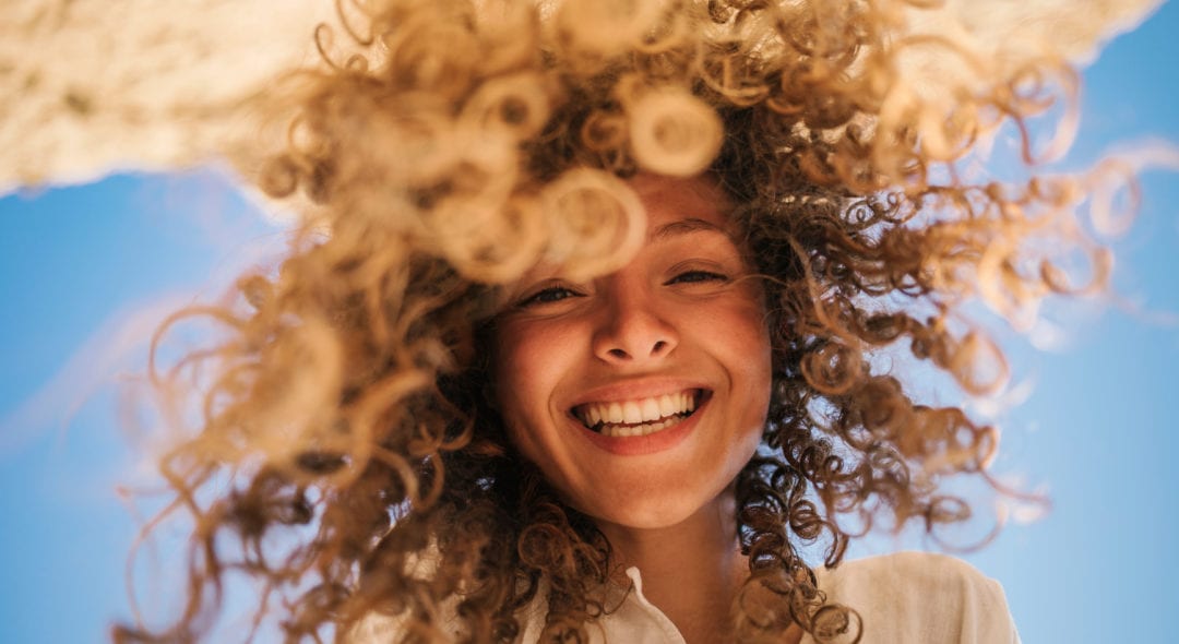 Happy Young Woman At The Beach
