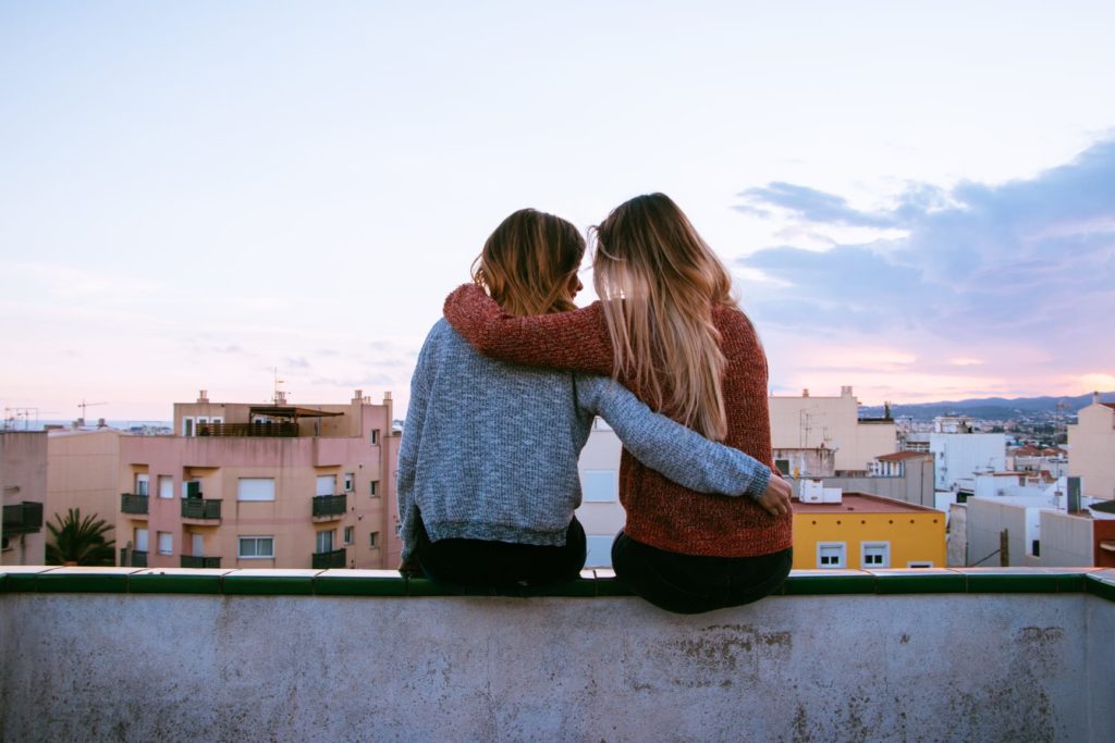 Friends sitting on the balcony, watching the sunset