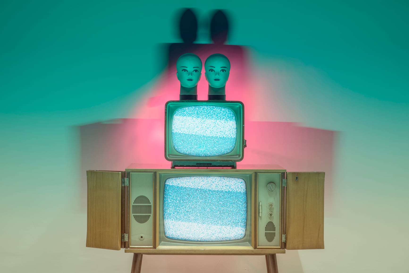 neon light experiment with retro TVs and doll heads