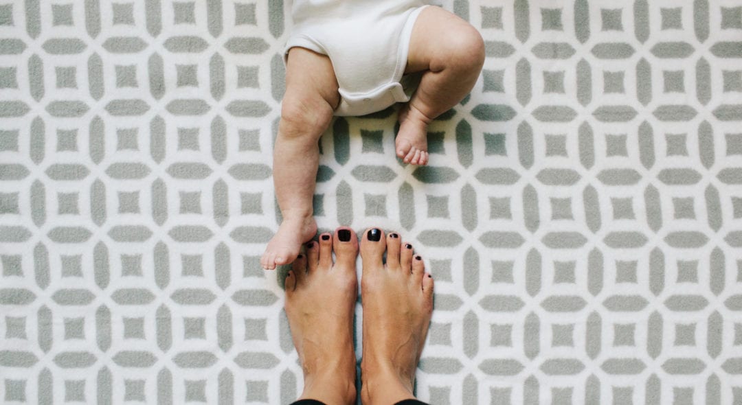 Mother Standing By Her Baby