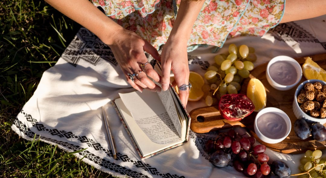 Woman doing a Vegan pic-nic outdoor, enjoying a sunny day with natural hand made vegan food.