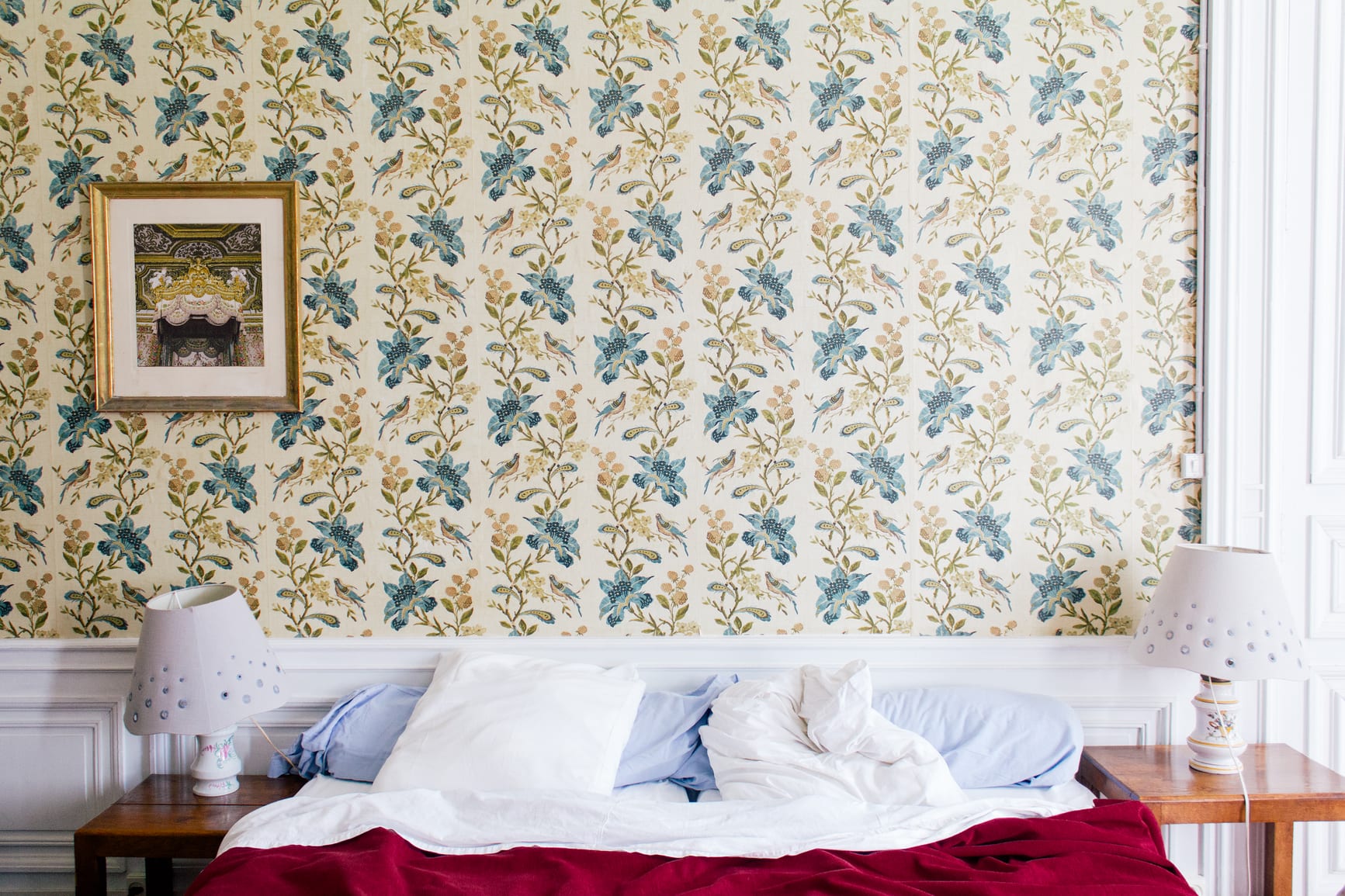 French vintage bedroom furniture with beautiful floral pattern wallpaper in the old castle.