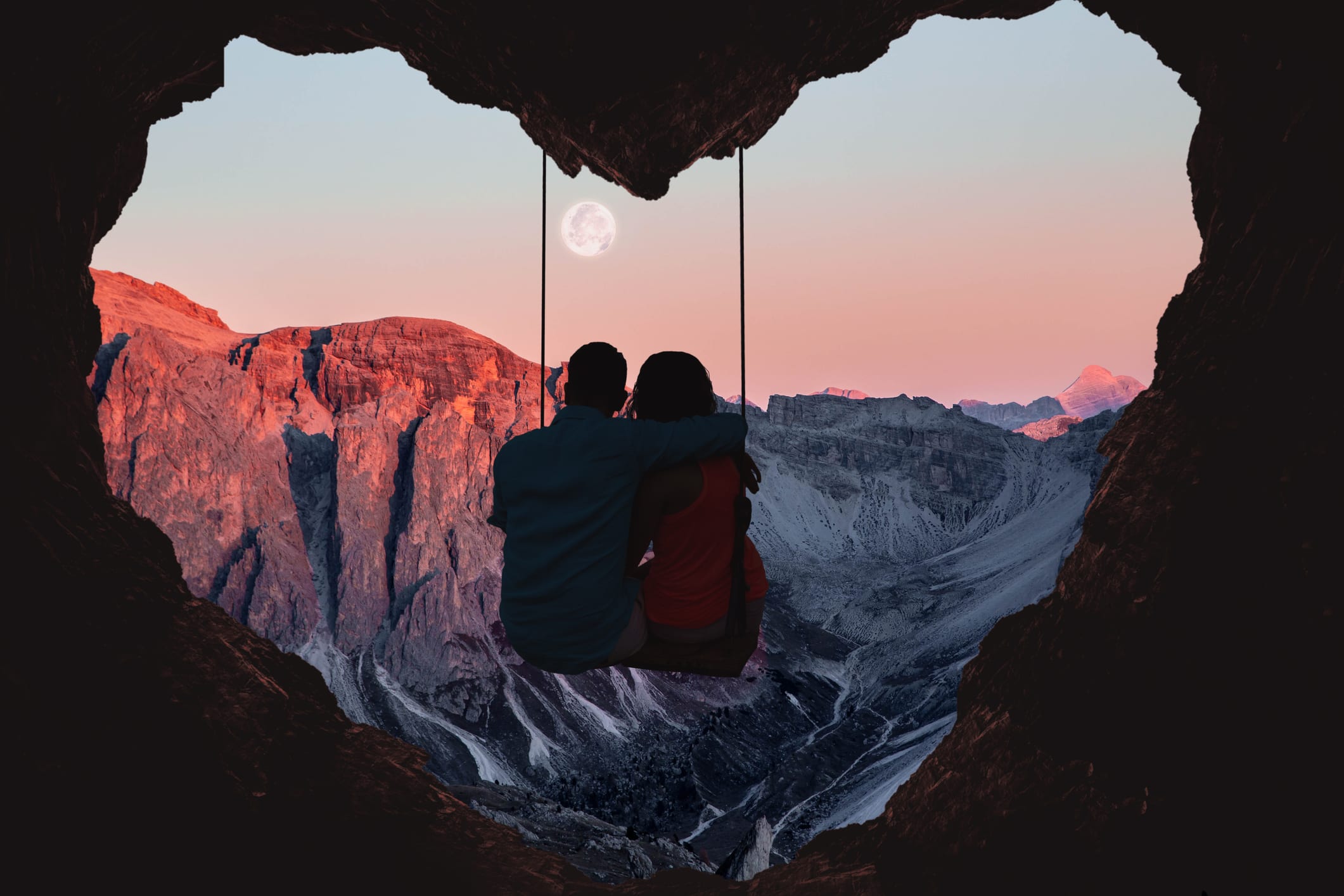 Composition of the Alps mountains during sunset with full moon and couple on swing from a heart shape cave.