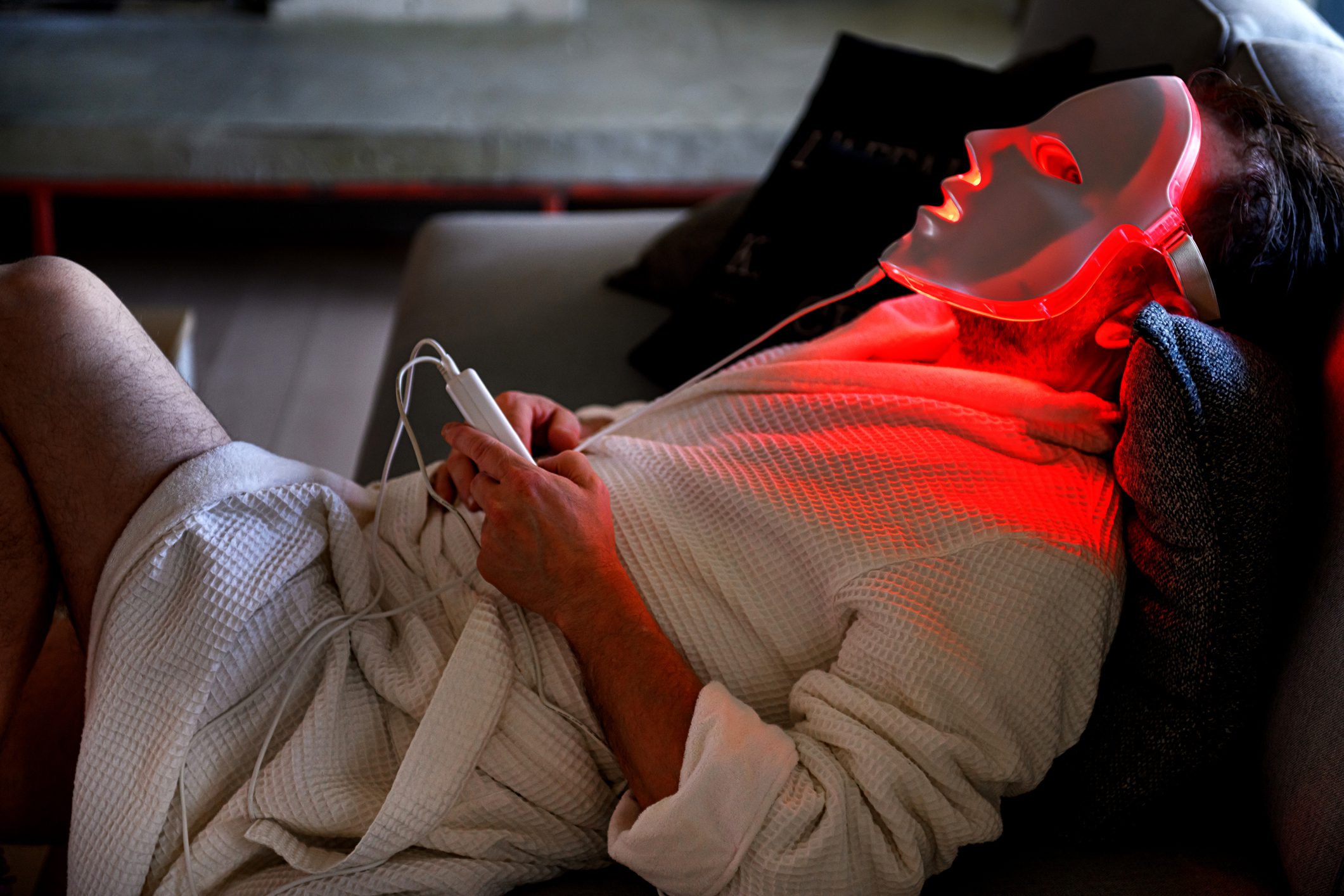 Mature man, during quarantine, trying a light therapy mask at night, Quebec, Canada