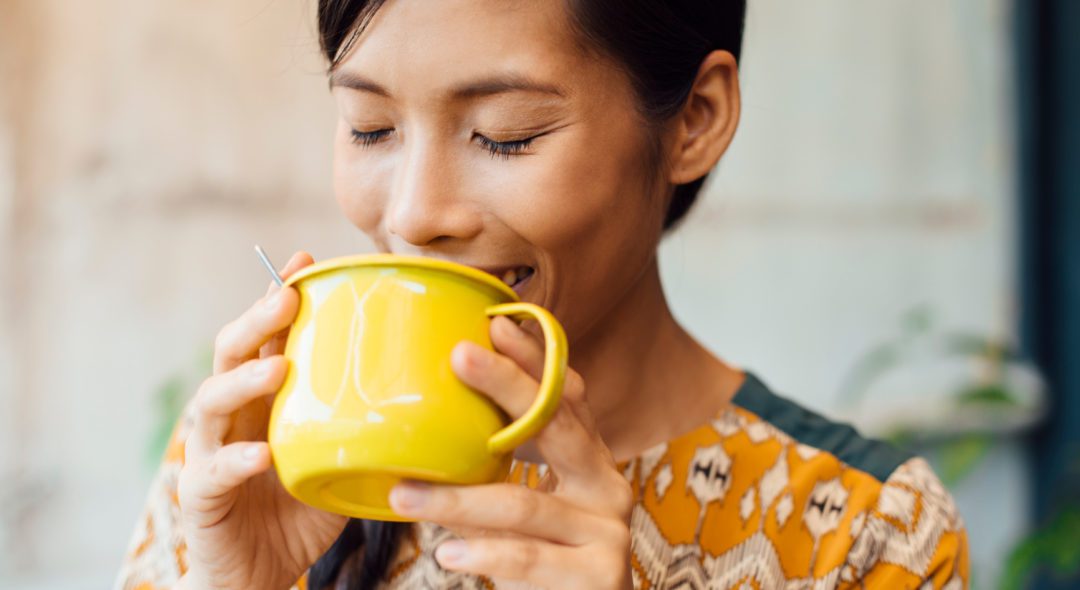 Asian Woman Having Tea/coffee On Balcony