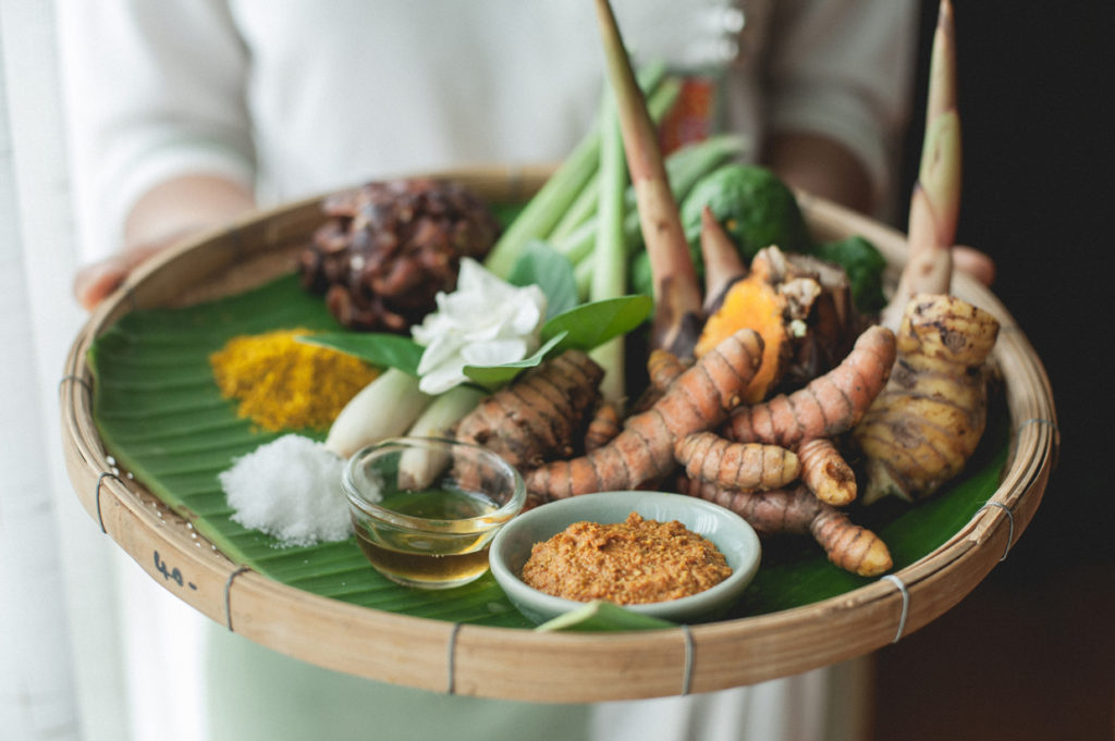 woman holding turmeric herb platter