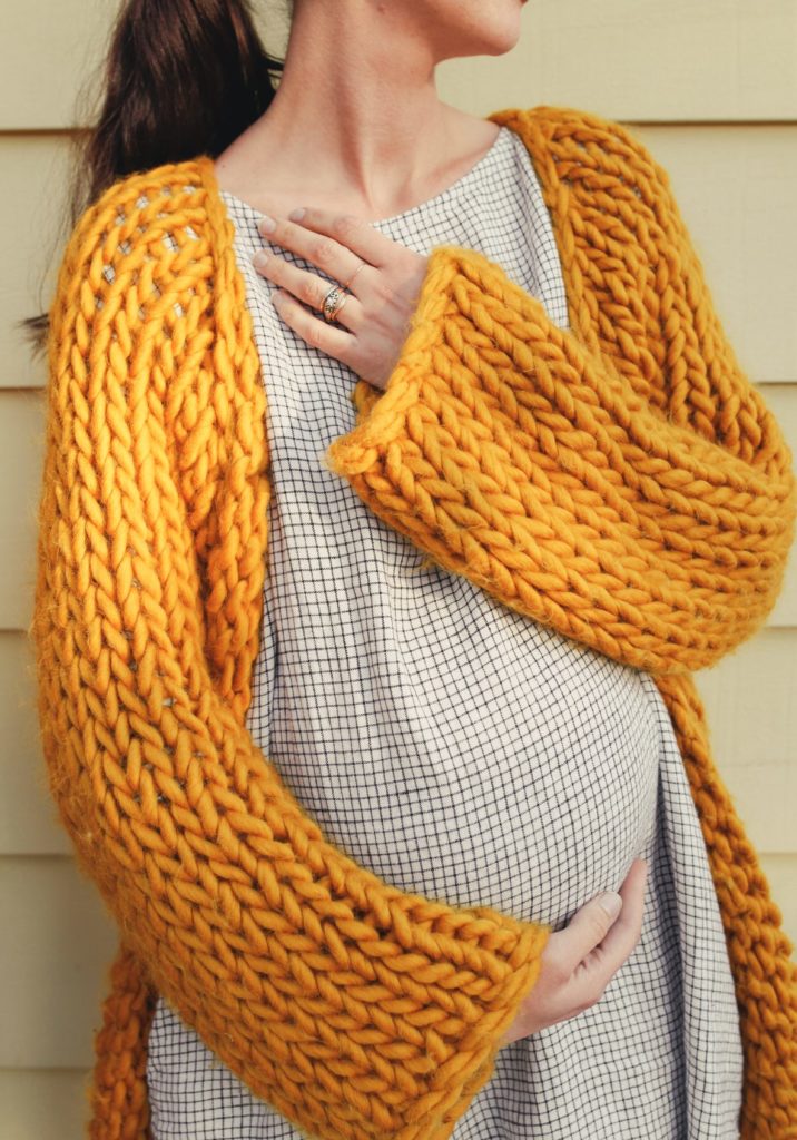 cozy knit sweater on a pregnant woman