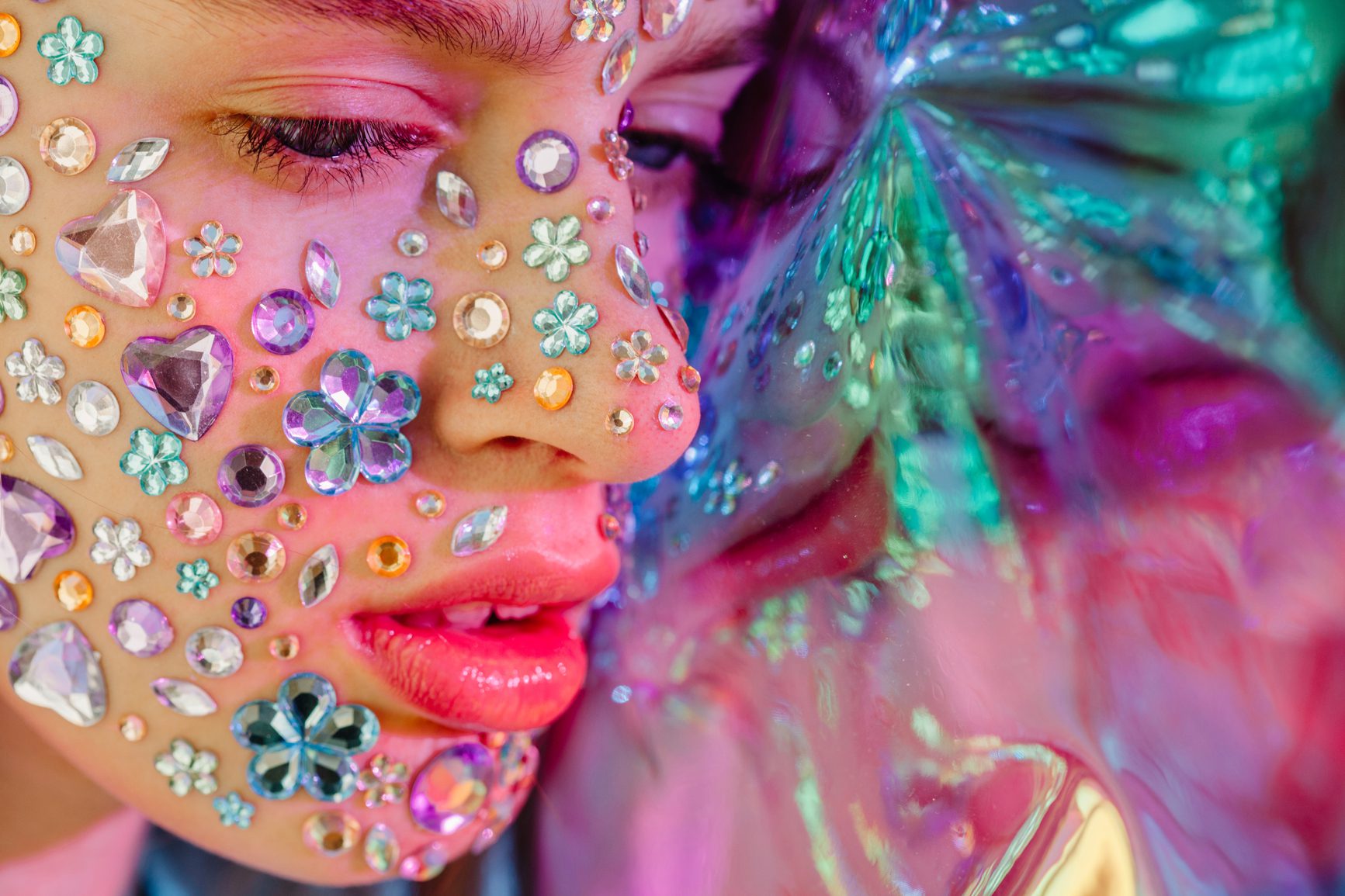 Side view beauty portrait of teen girl with rhinestones on her face
