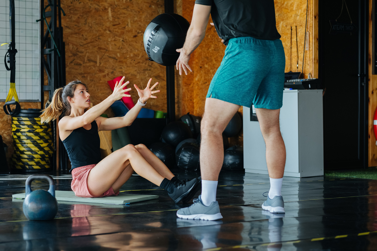 Woman and Man Working Out in Gym