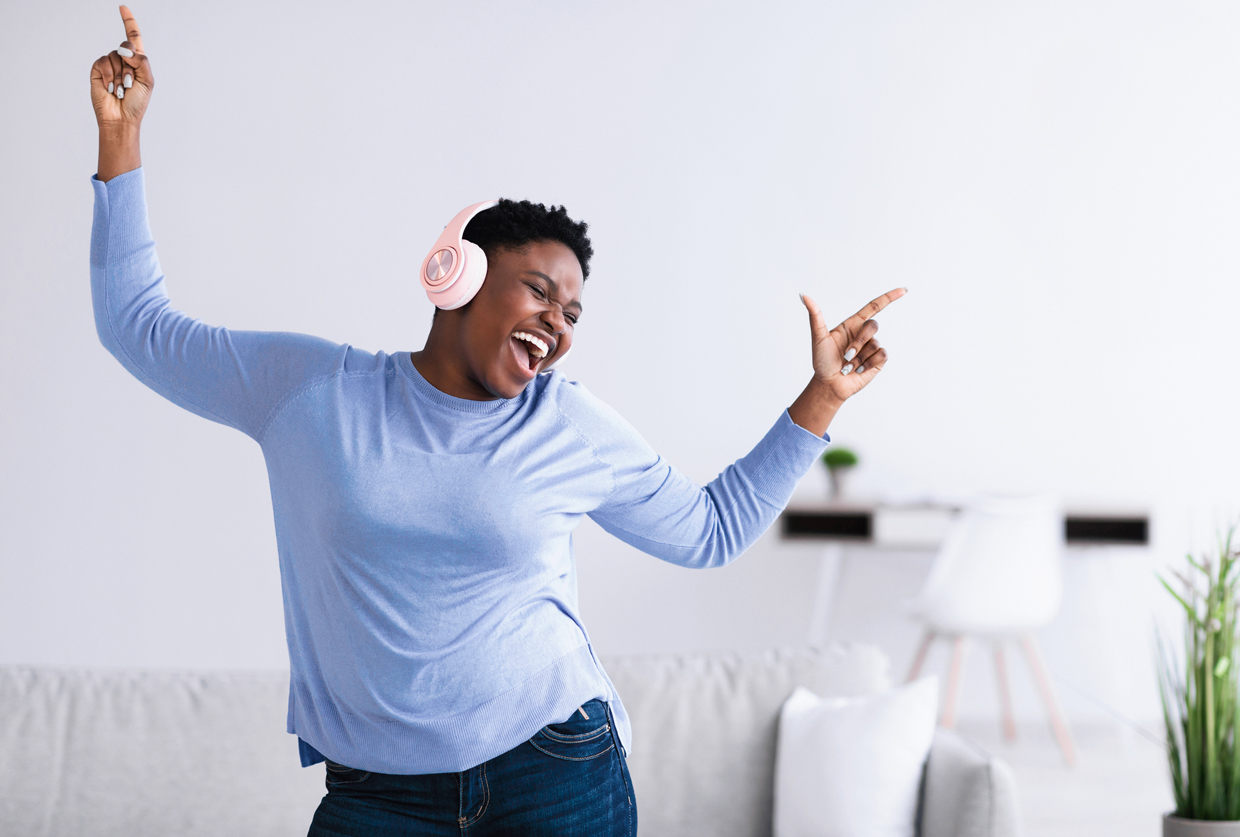 woman listening to music in headphones and dancing