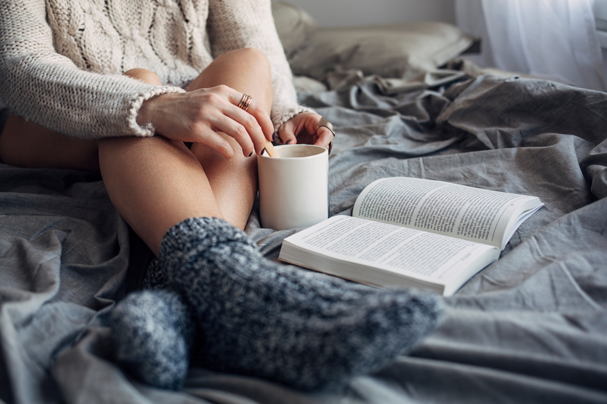 Woman Reading a Book in Bed in the Morning
