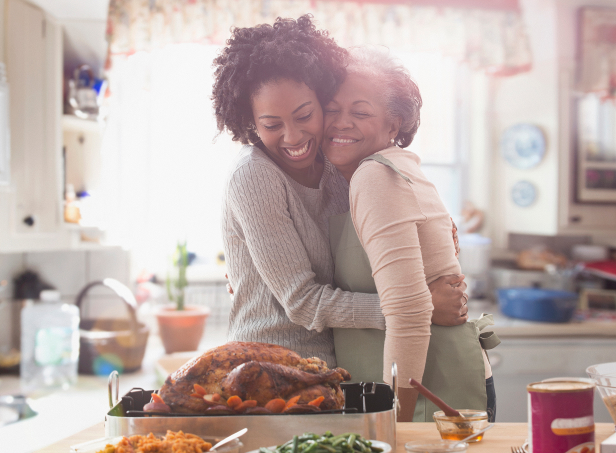 Mother and daughter cooking together in kitchen