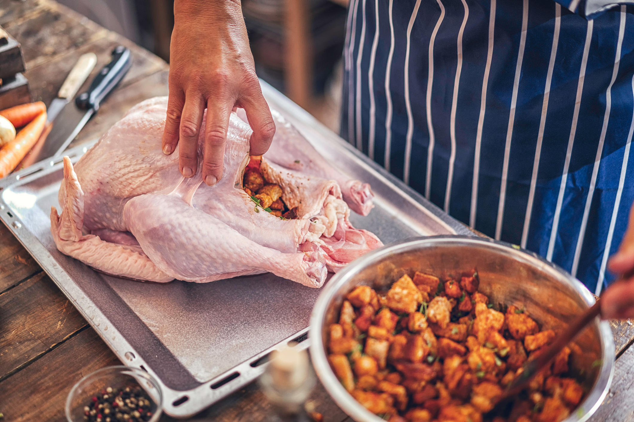 Preparing stuffed turkey with vegetables and other ingredients for holidays