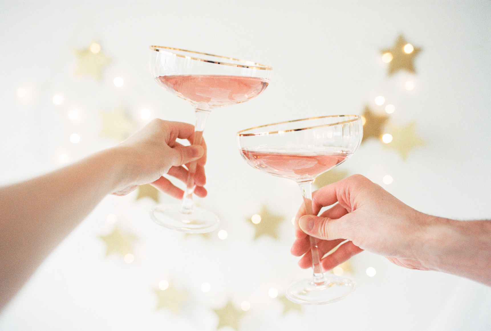 two people holding champagne glasses