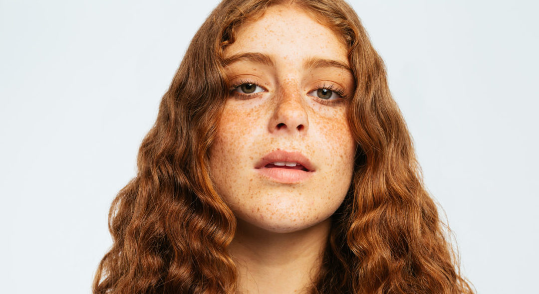 portrait of woman with curly red hair