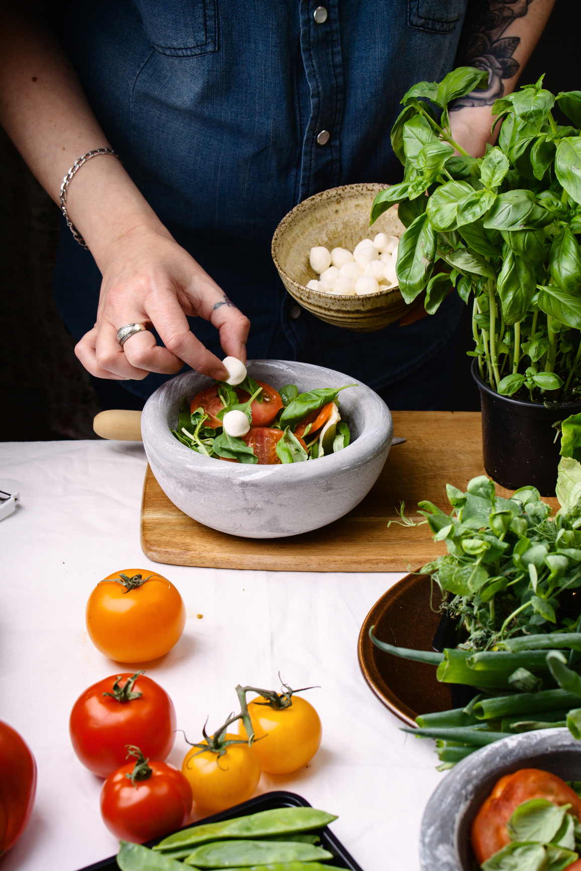 Woman preparing mozzarella salad