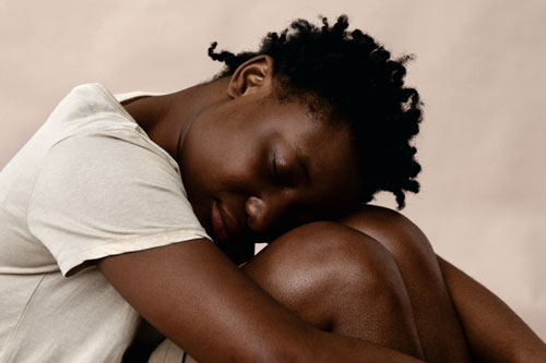woman in studio embracing herself