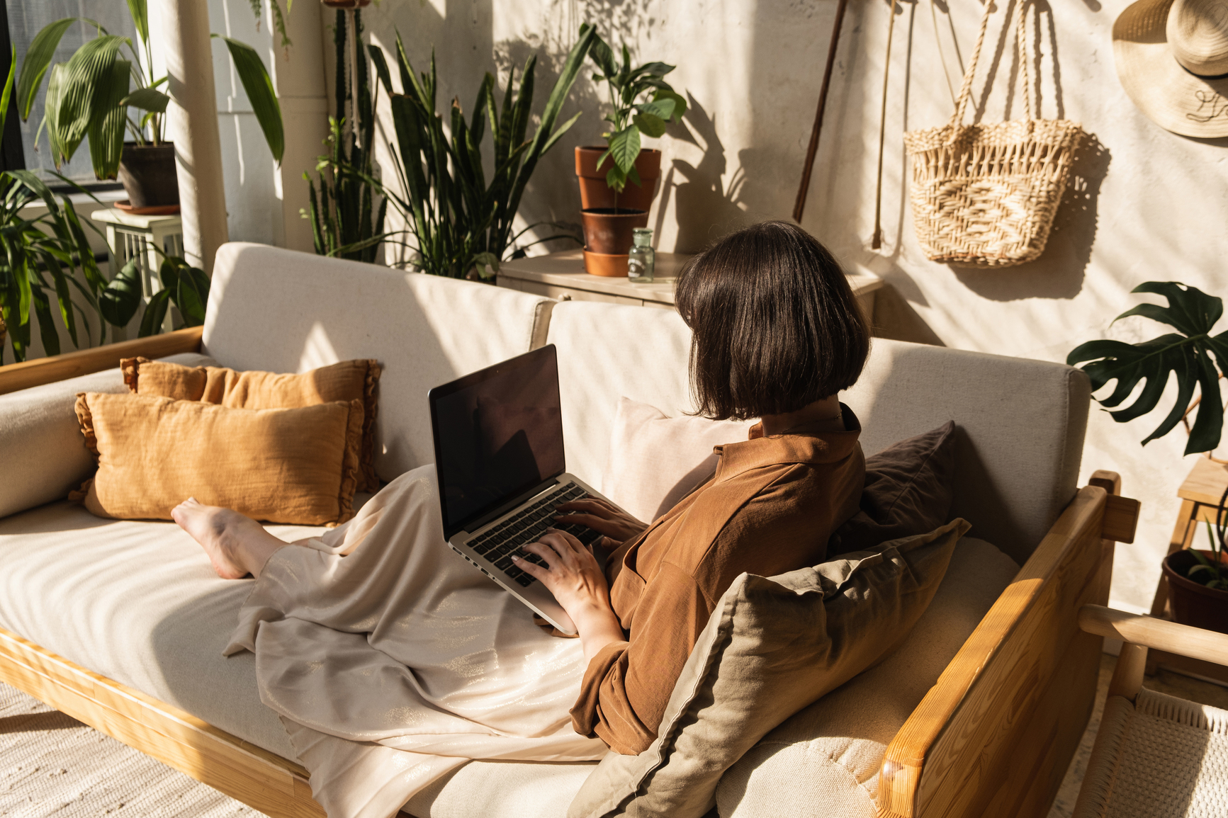 woman sitting in couch working from home
