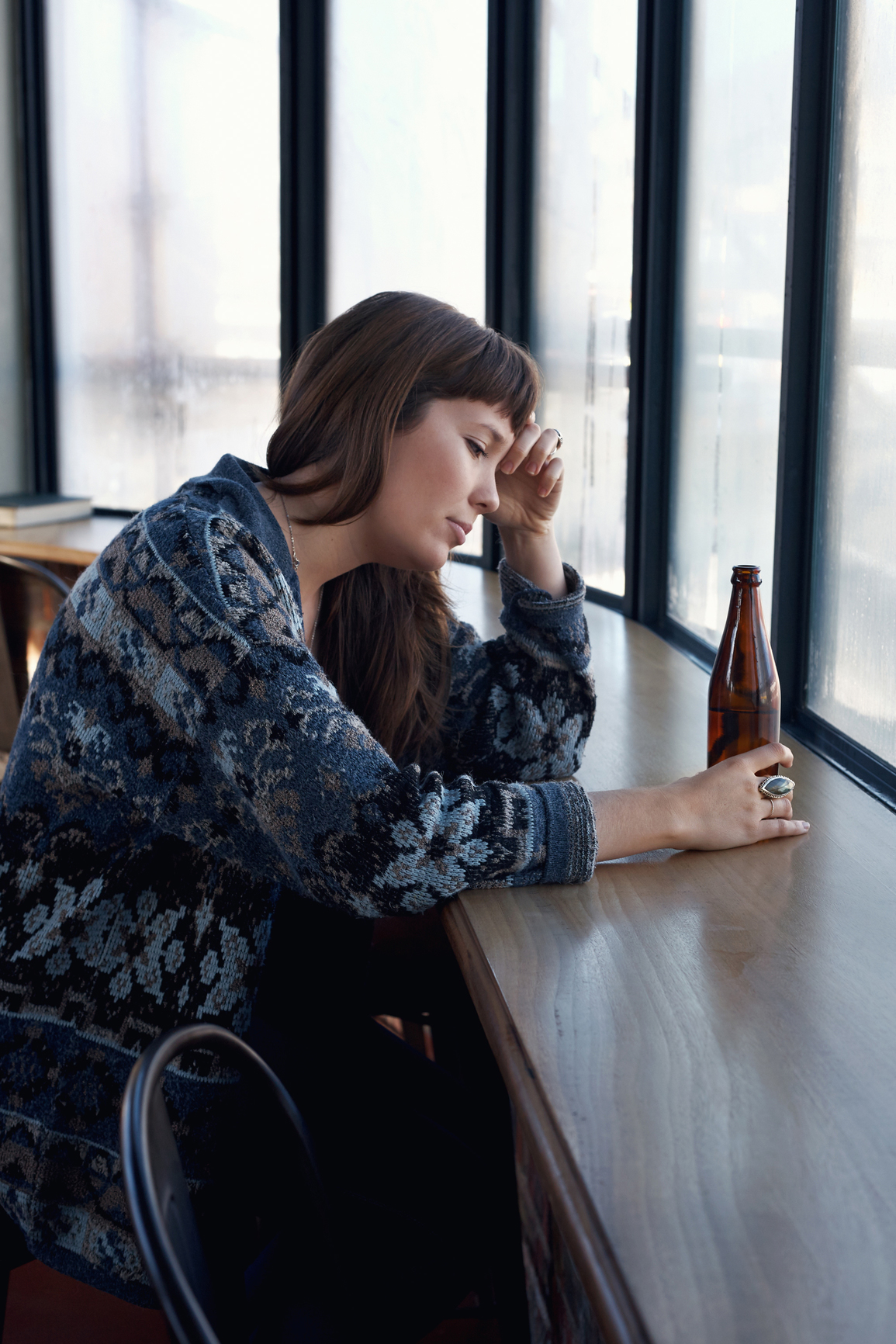 sad woman drinking a beer