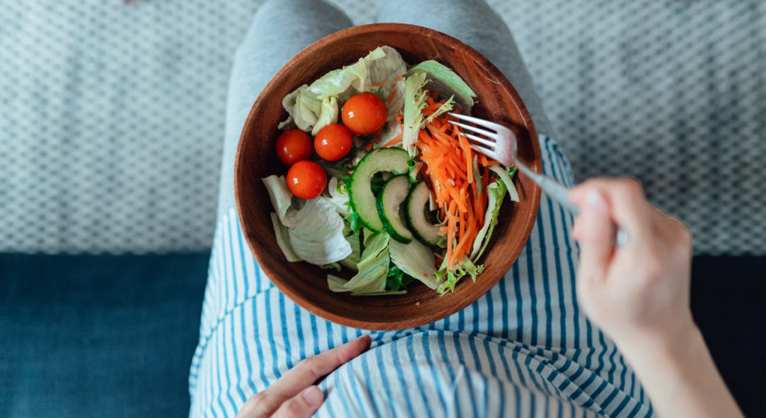 Overhead Shot Of Pregnant Woman Eating Vegetable Salad