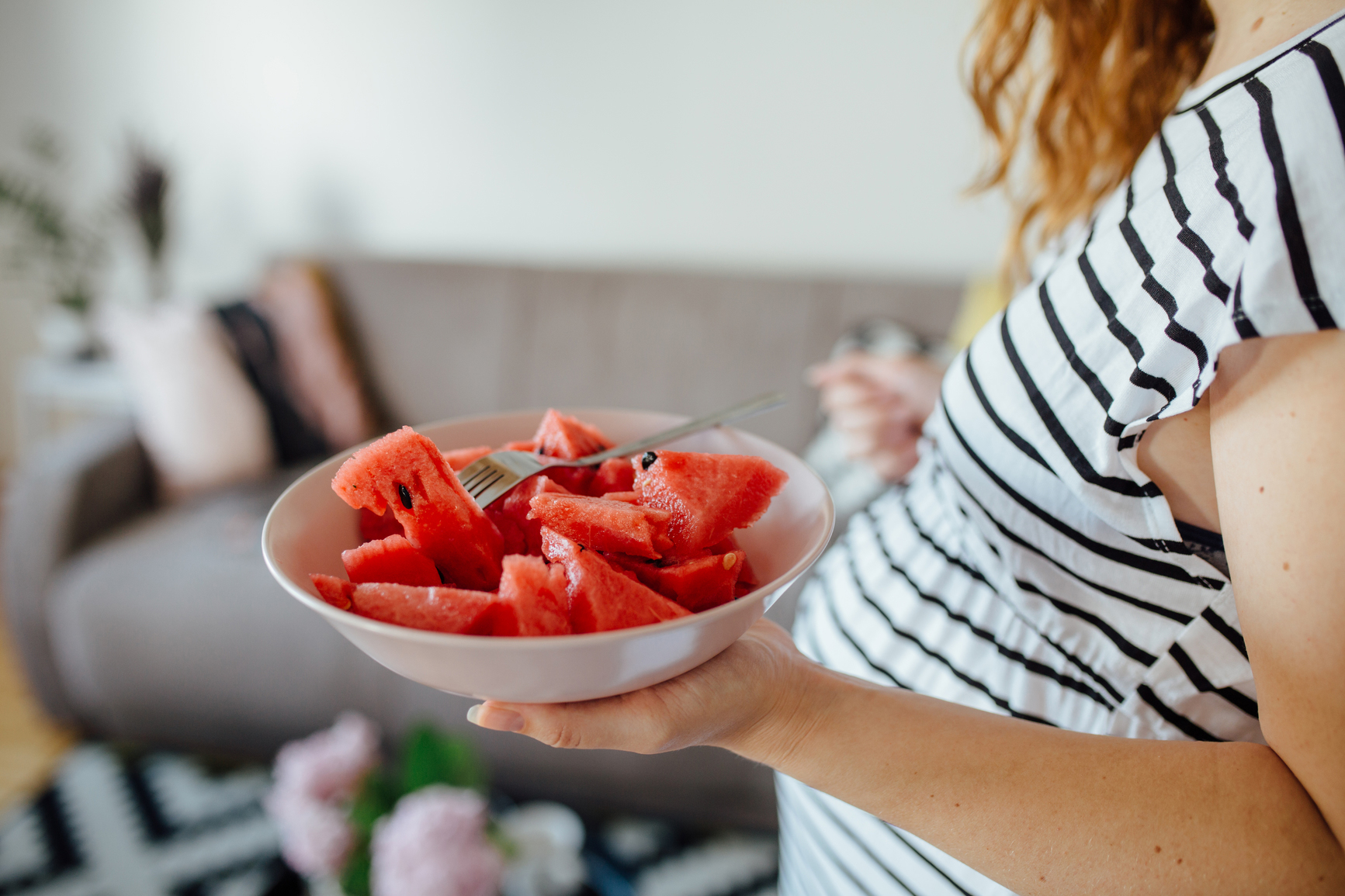Pregnant woman eating watermelon
