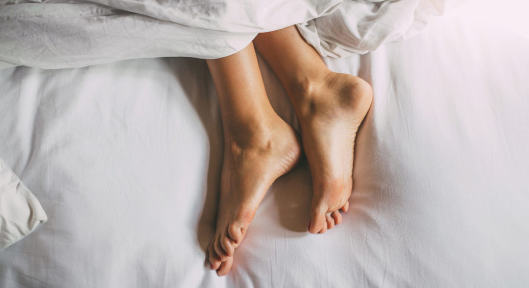 woman feet laying in bed