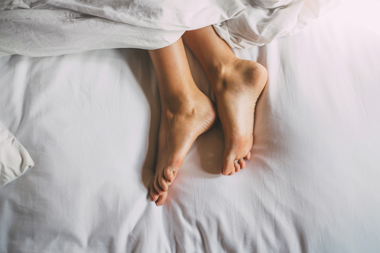 woman feet laying in bed
