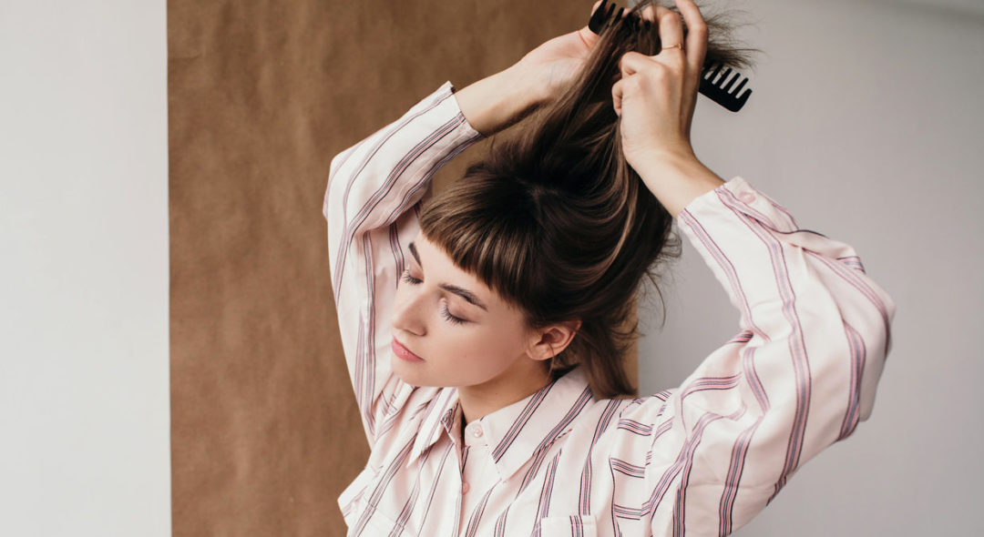 woman combing her hair