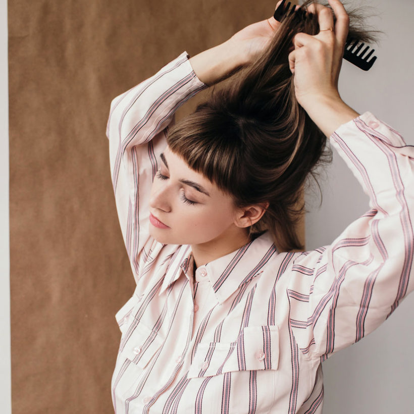 woman combing her hair