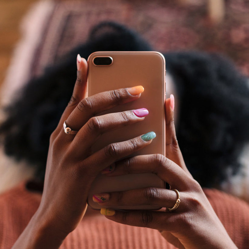 Unrecognizable woman scrolling on her phone