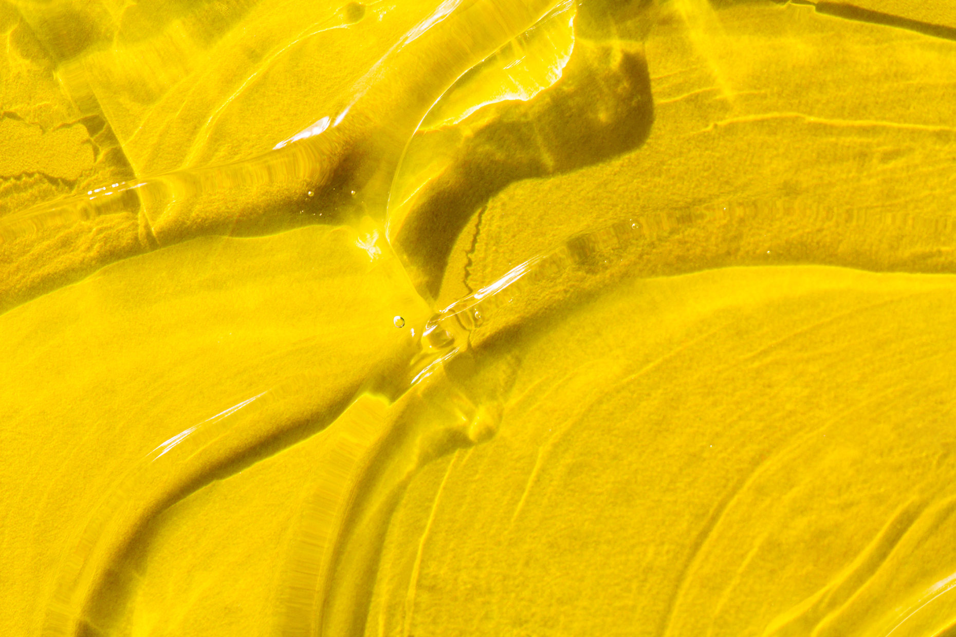 smears of cosmetic gel on bright illuminating yellow background