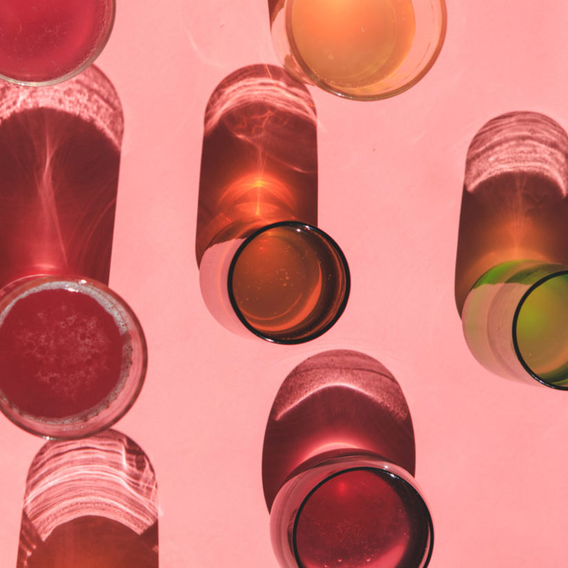 Colorful Kombucha Glasses Over Pink Solid Background