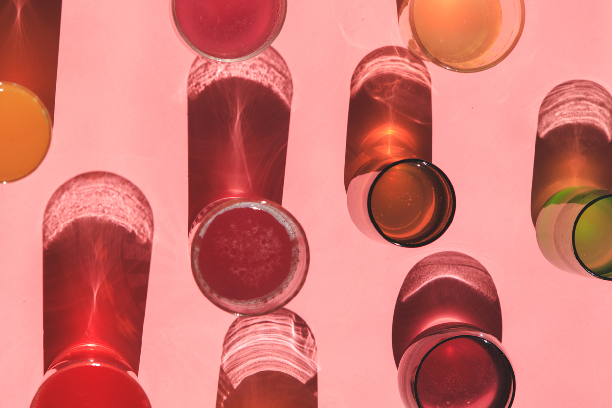 Colorful Kombucha Glasses Over Pink Solid Background