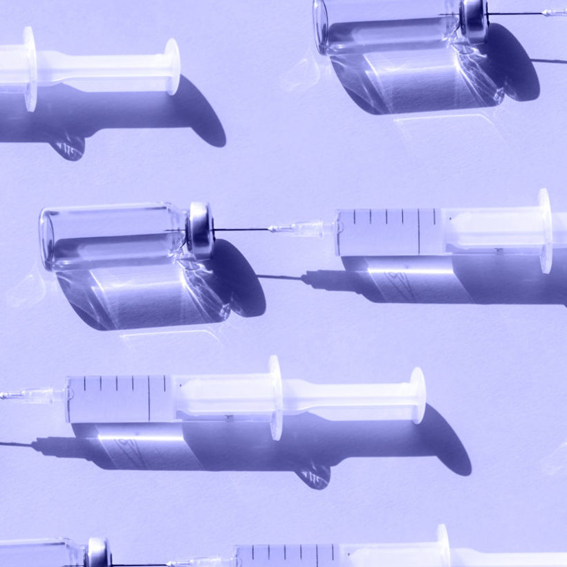 purple syringes on background