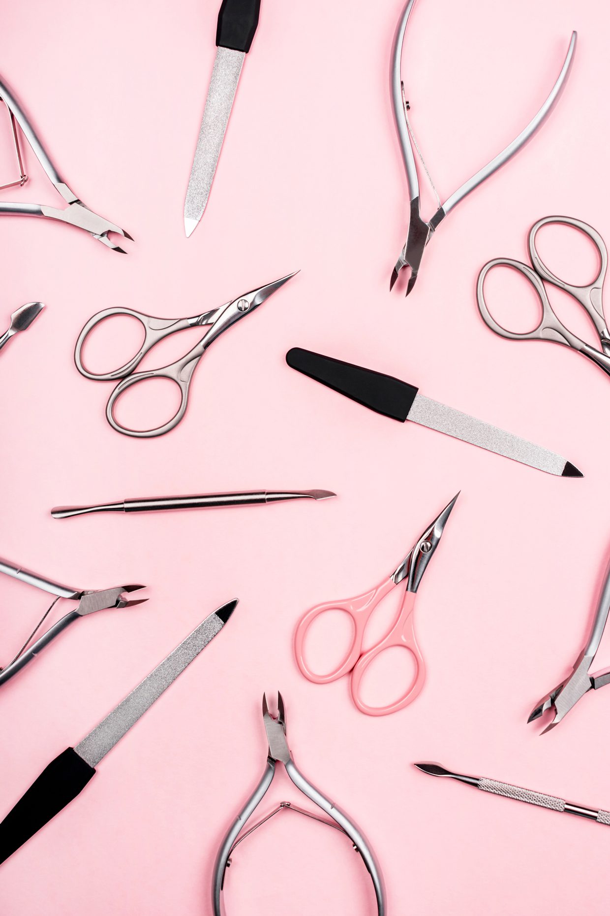 TitleSet of manicure tools on pastel pink background