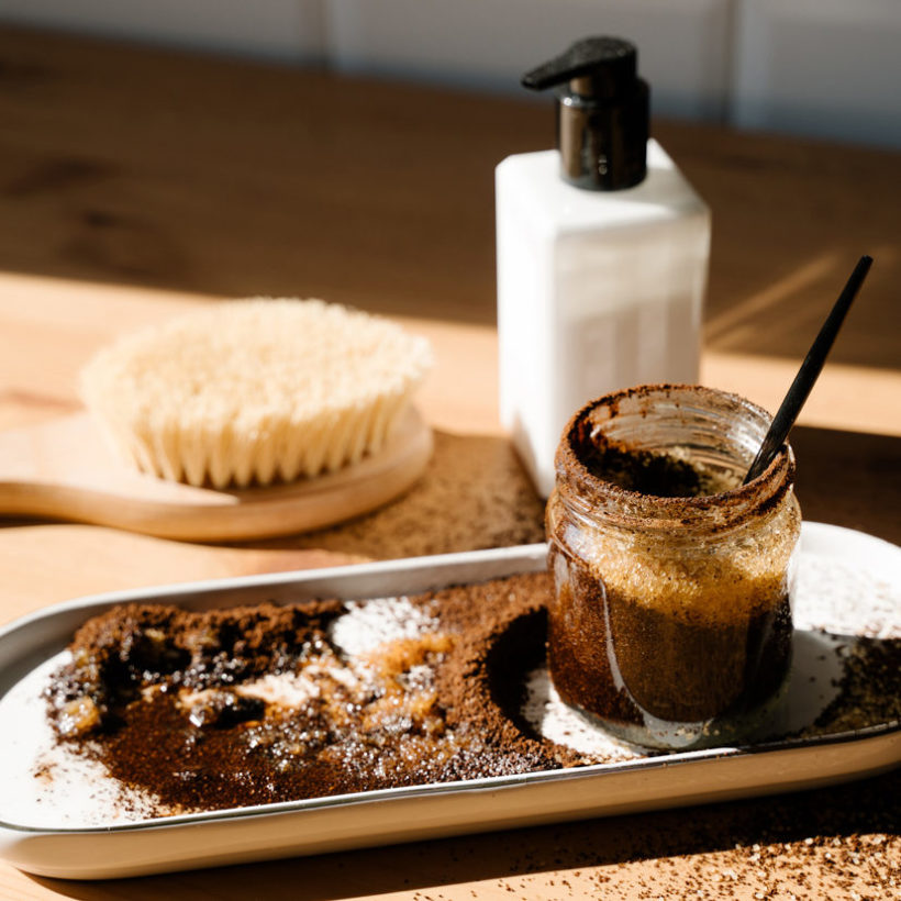 still life of coffee scrub, dry brush and skincare