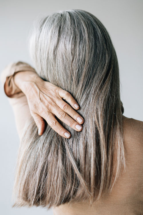 back view of woman with long gray hair
