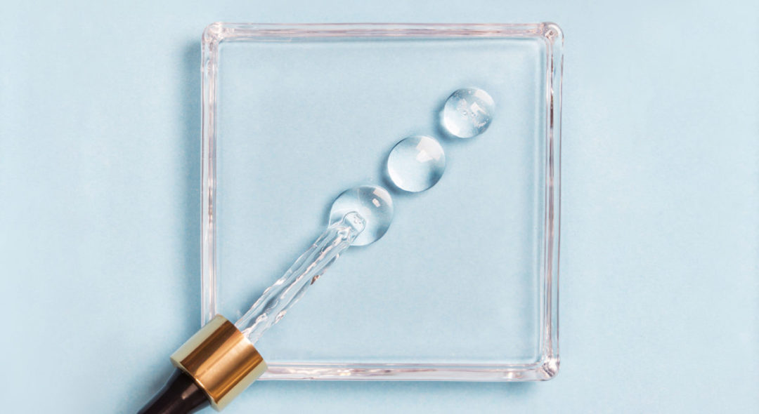 Drops of serum on a blue background medical concept Oxygen filled fluid