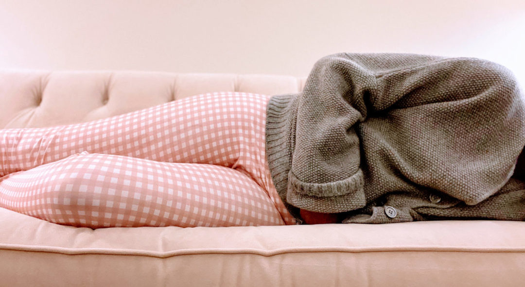 woman laying down in couch