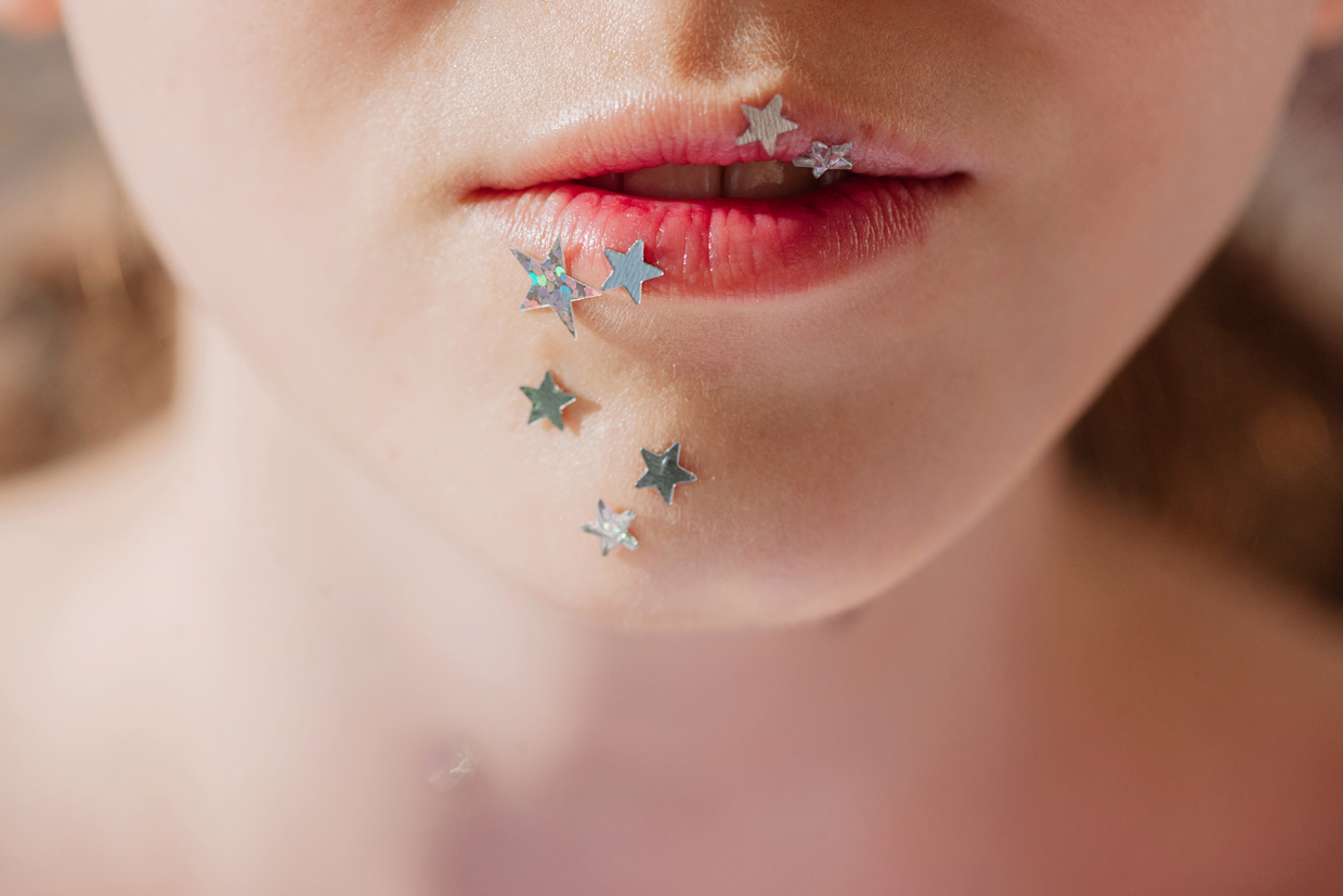 Crop photo of lips with silver stars make up