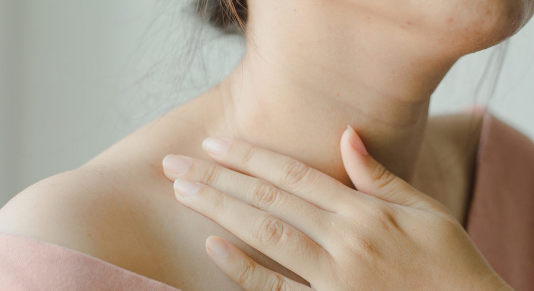 close up of woman touching her neck