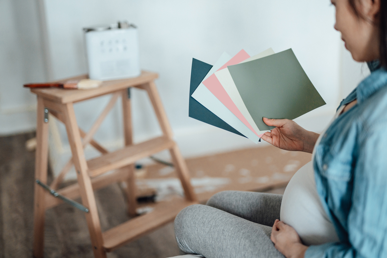 Pregnant Woman Renovating Nursery Room For Her Newborn Baby