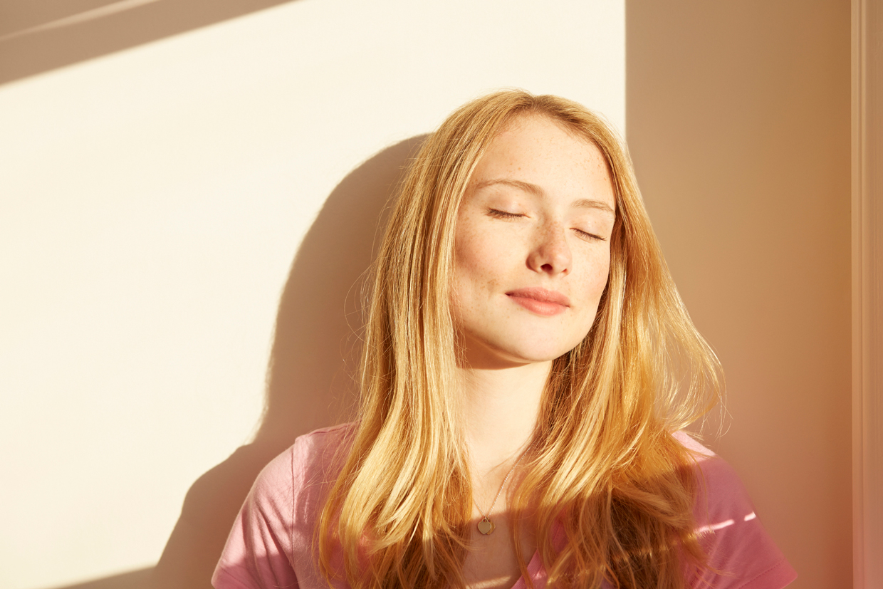 woman, outdoors, in sunlight, eyes closed