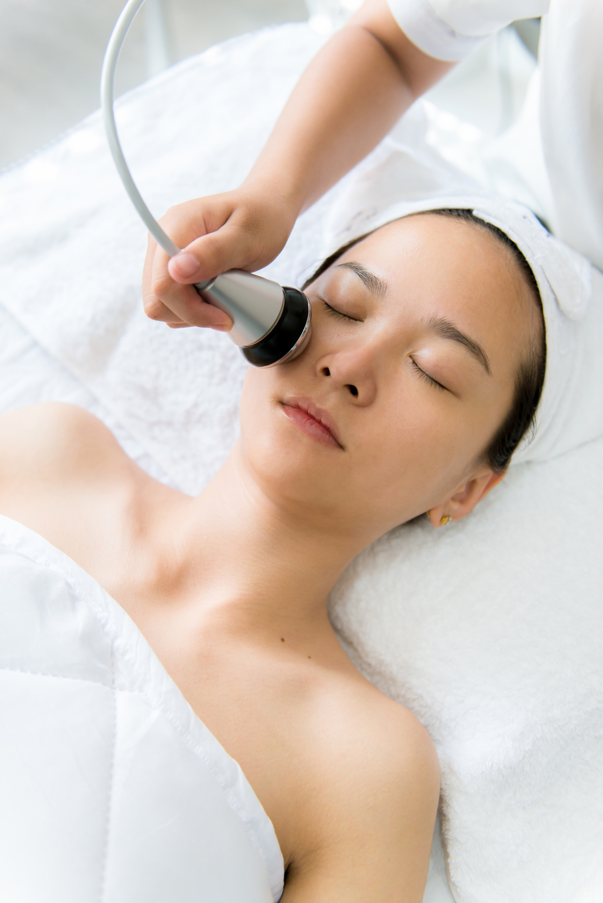 Woman receiving facial treatment