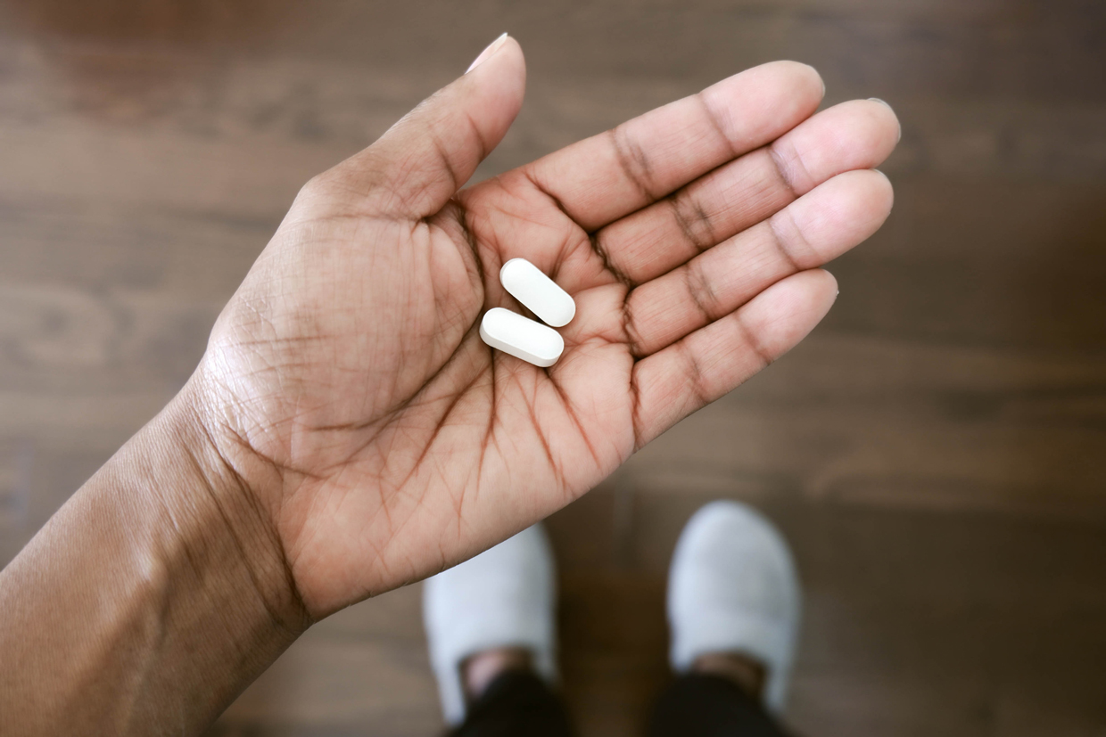 person holding pills